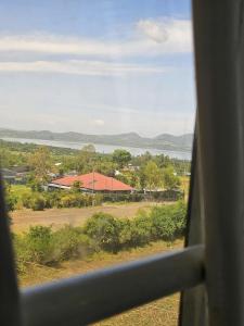 a view from a train window of a field and a building at Allan BnB HomaBay in Homa Bay