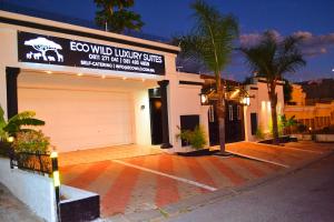 a building with a garage with a sign on it at ECO-WILD Luxury Suites in Windhoek