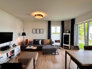 a living room with a couch and a table at Vinkennest am Diemelsee - Sonnenweg 44 1 VN in Diemelsee