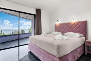 a bedroom with a large bed and a large window at Villa Viola in Lovran +26 photos