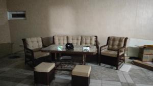 a living room with a table and two chairs at Nino in Kaspi