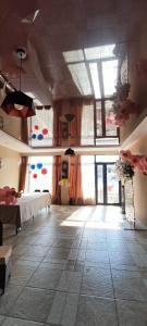 a large room with a table and a large window at Nino in Kaspi