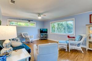 a living room with blue walls and a couch and chairs at Pool Access! Private Island Condo in Placida in Placida