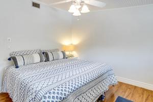 a bedroom with a bed with a blue and white comforter at Pool Access! Private Island Condo in Placida in Placida +26 photos