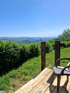 a chair sitting on a wooden deck with a view at Douglas in Saint-Racho
