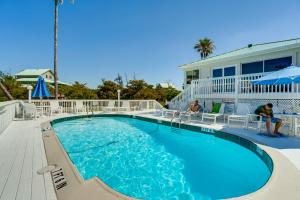 a swimming pool in front of a house at Pool Access! Private Island Condo in Placida in Placida