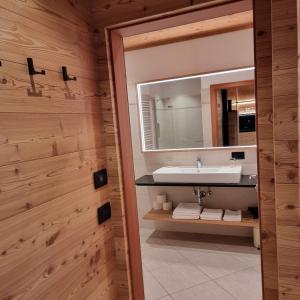a bathroom with a sink and a mirror at Chalet Residence Alpinflair in Ortisei +96 photos