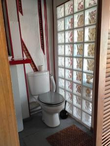 a bathroom with a toilet and a glass door at Chambre en Havre de paix in Panazol
