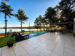 an outdoor patio with a pool and a table and chairs at Casa Ypá in Puerto Libertad +10 photos