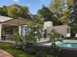 a house with a swimming pool in a yard at Casa Ypá in Puerto Libertad