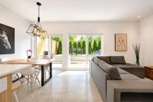 a living room with a couch and a table at Amazing 2BR condo with private terrace presented by TripMontreal II in Montreal