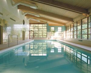 a large swimming pool in a building at Denham Grove in Denham