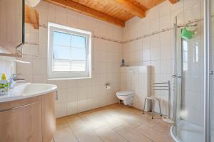 a bathroom with a toilet and a sink and a shower at Friesenperle in Greetsiel +23 photos