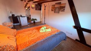 a bedroom with a bed with an orange comforter at Golden Boutique in Basel +9 photos