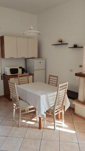 a table and chairs in a kitchen with a table and a table and a table at Casa Vanda in Orte