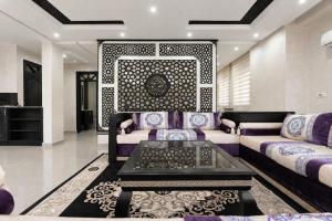 a living room with a couch and a table at Tamraght Ocean View in Tamraght Ouzdar
