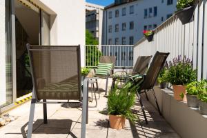 a row of chairs sitting on a balcony at Hotel Mondial Munich in Munich
