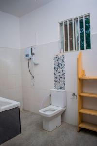 a bathroom with a toilet and a sink at Almasi lounge in Arusha +14 photos