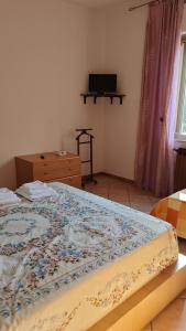 a bedroom with a bed with a quilt on it at Casa Vanda in Orte