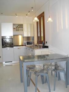 a kitchen with a table and chairs and a refrigerator at Salmaso Apartments in Venice