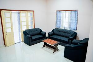 a living room with two chairs and a coffee table at Naga Vasa in Jaffna