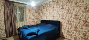 a bedroom with a bed with a dolphin on the wall at Nino in Kaspi