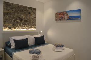 a bedroom with two beds and a painting on the wall at La Perla Marina in Manarola