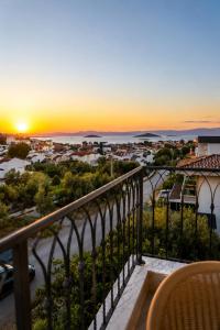 a view of a sunset from a balcony at Kent Pansiyon Ayvalık in Ayvalık