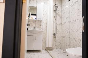 a bathroom with a toilet and a sink at Kent Pansiyon Ayvalık in Ayvalık +38 photos