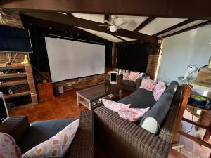 a living room with two couches and a large screen at Natura Escapade in Torrox +27 photos
