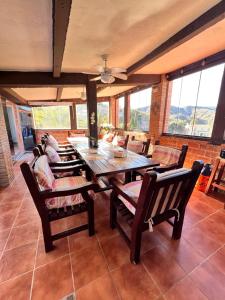 a dining room with a wooden table and chairs at Natura Escapade in Torrox