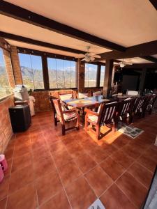 a dining room with a table and chairs and windows at Natura Escapade in Torrox