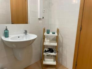a bathroom with a sink and a mirror at Brisa de Milfontes in Vila Nova de Milfontes