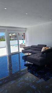 a living room with a couch and some water at Montebello Inn apartments in Ulcinj