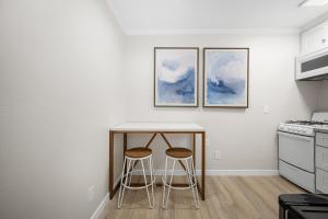 a kitchen with a table and two stools at 1628 West Oceanfront Oasis 6 in Newport Beach