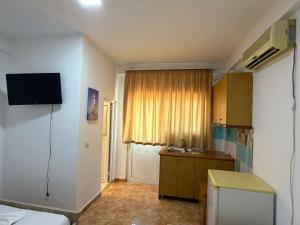 a small kitchen with a sink and a room at Aria Apartments in Borsh