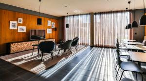 a waiting room with chairs and a table at Hotel Garni Maximilian in Dingolfing +15 photos