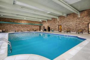 a large swimming pool in a building with a brick wall at Best Western Woodhaven Inn in Woodhaven