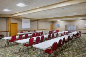 a conference room with white tables and red chairs at Best Western Woodhaven Inn in Woodhaven +29 photos