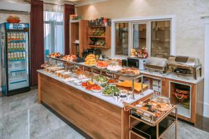 a buffet in a hotel with a lot of food at Silk Road Empire in Samarkand