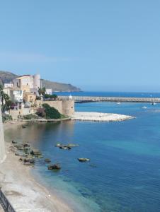 a group of rocks in a body of water at A Petrazzi in Castellammare del Golfo