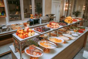 a buffet with many plates of food on a table at Silk Road Empire in Samarkand
