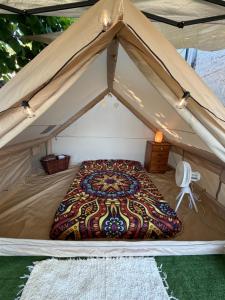 a tent with a bed in the middle at La Somavan Tambu in Xàtiva +21 photos