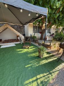 a large tent in a yard with a green lawn at La Somavan Tambu in Xàtiva