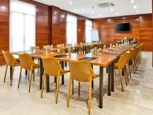 a large conference room with wooden walls and tables and chairs at Sercotel AB Arganda in Arganda del Rey +53 photos