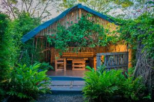a garden with a bench and a fence at Almasi lounge in Arusha