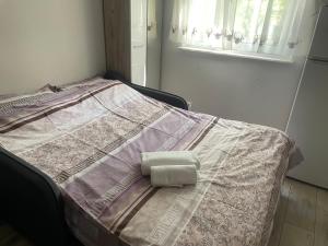 a bed with a towel on top of it at Suite4Rent Iași in Iaşi