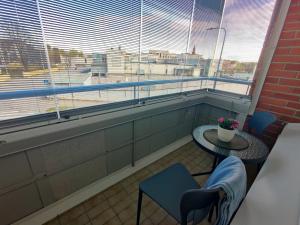 a room with a table and a chair and a window at Room Sonaatti in Savonlinna