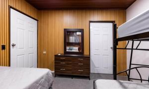 a bedroom with a bed and a dresser with a mirror at Apartamentos Javi in Tela