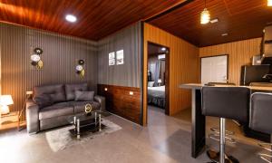 a living room with a couch and a bed at Apartamentos Javi in Tela